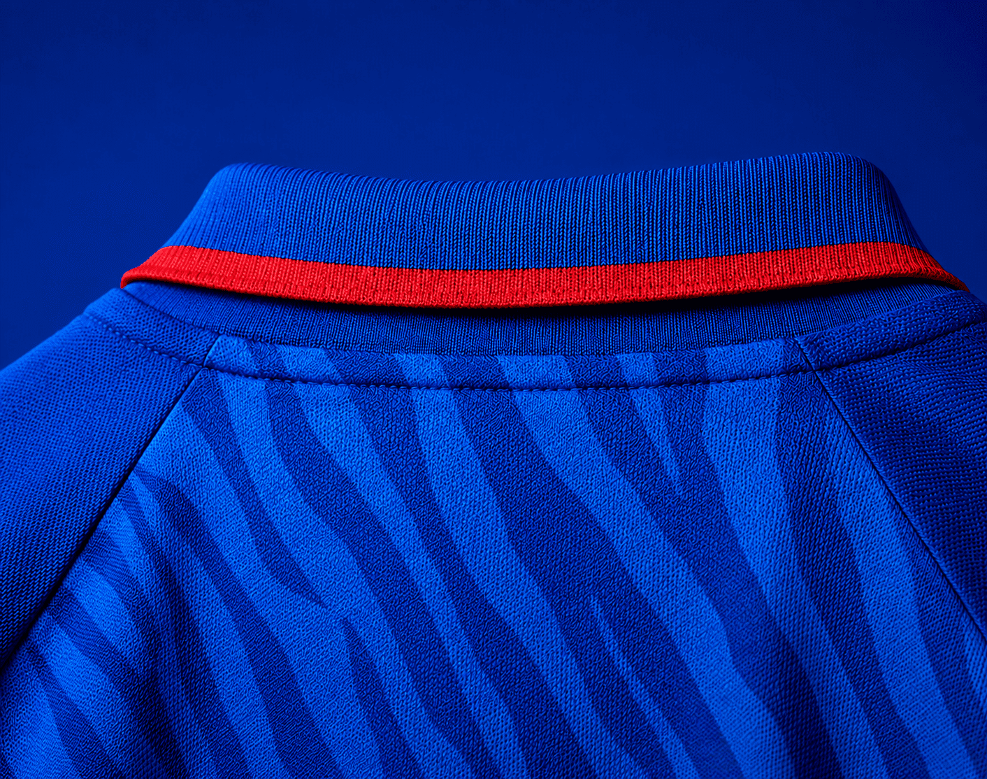 Close-up of the Delhi Capitals IPL 2026 jersey collar with red trim and tonal tiger stripes