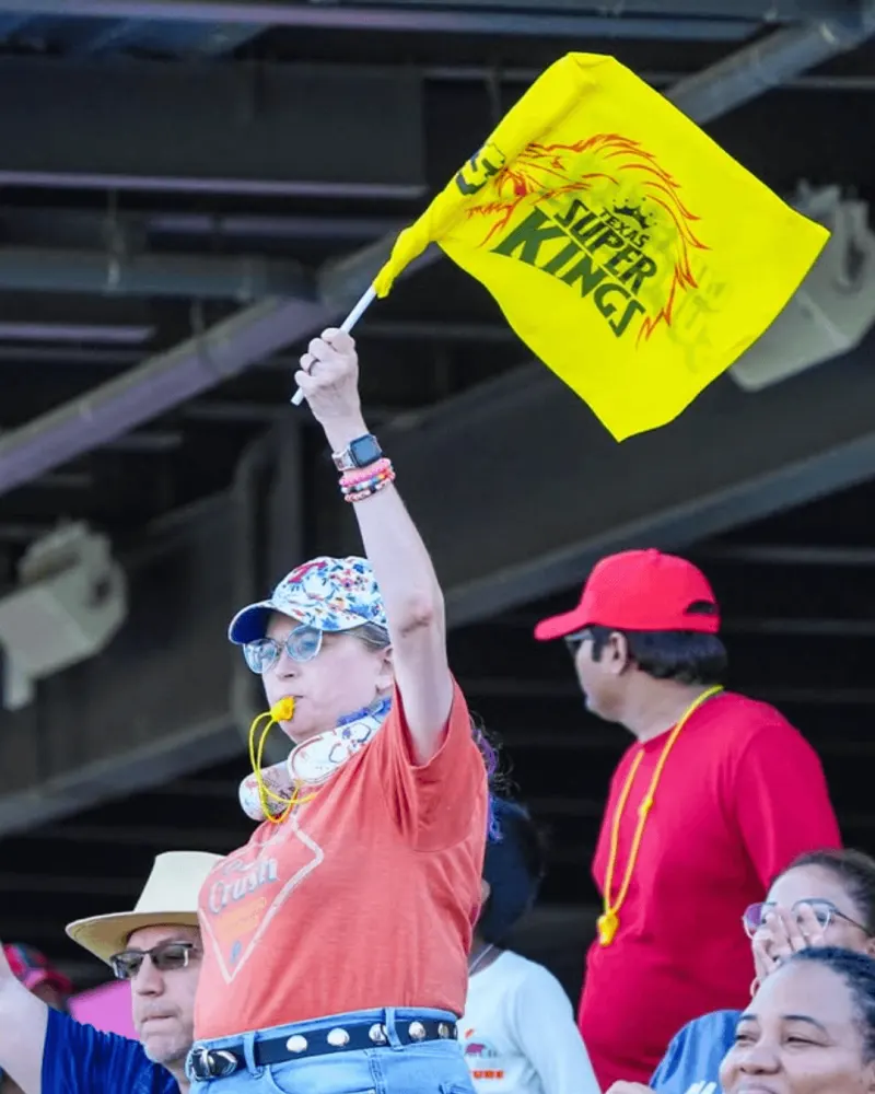 A fan waving a Super Kings flag at the stadium