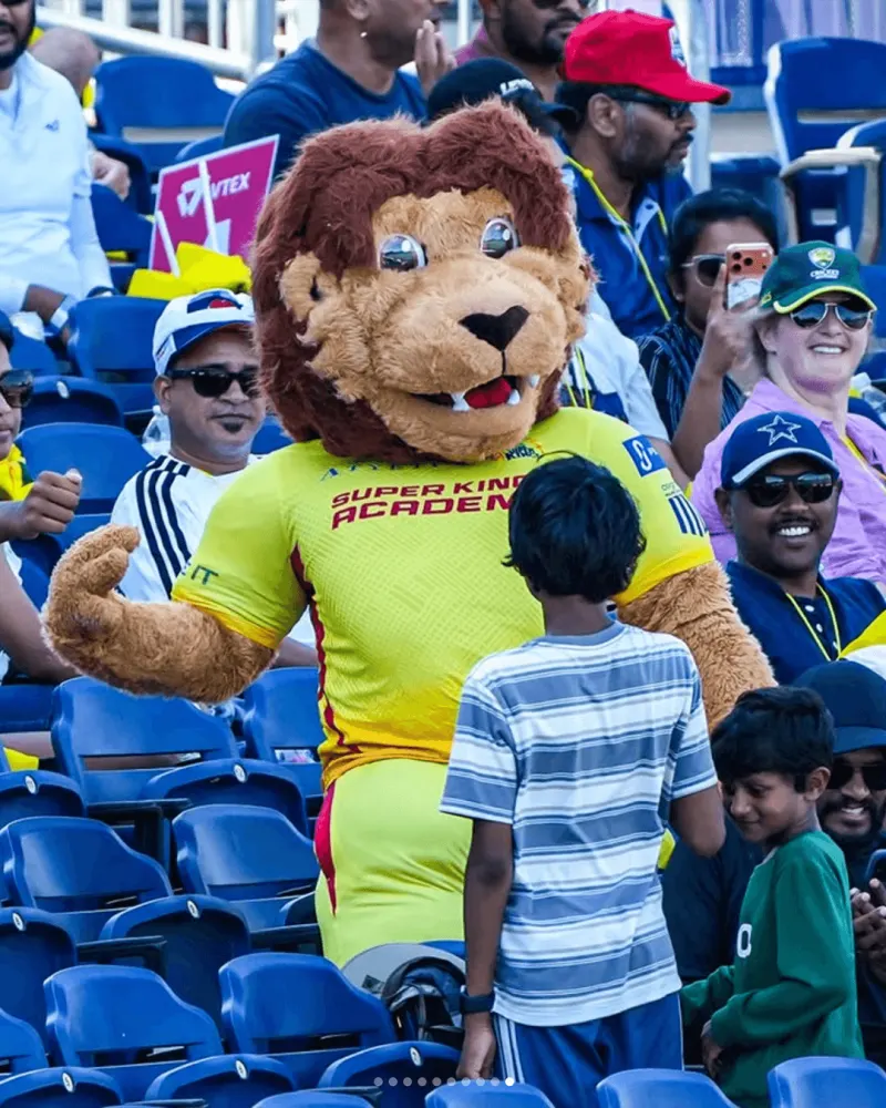 Texas Super Kings mascot with young fans in the stands