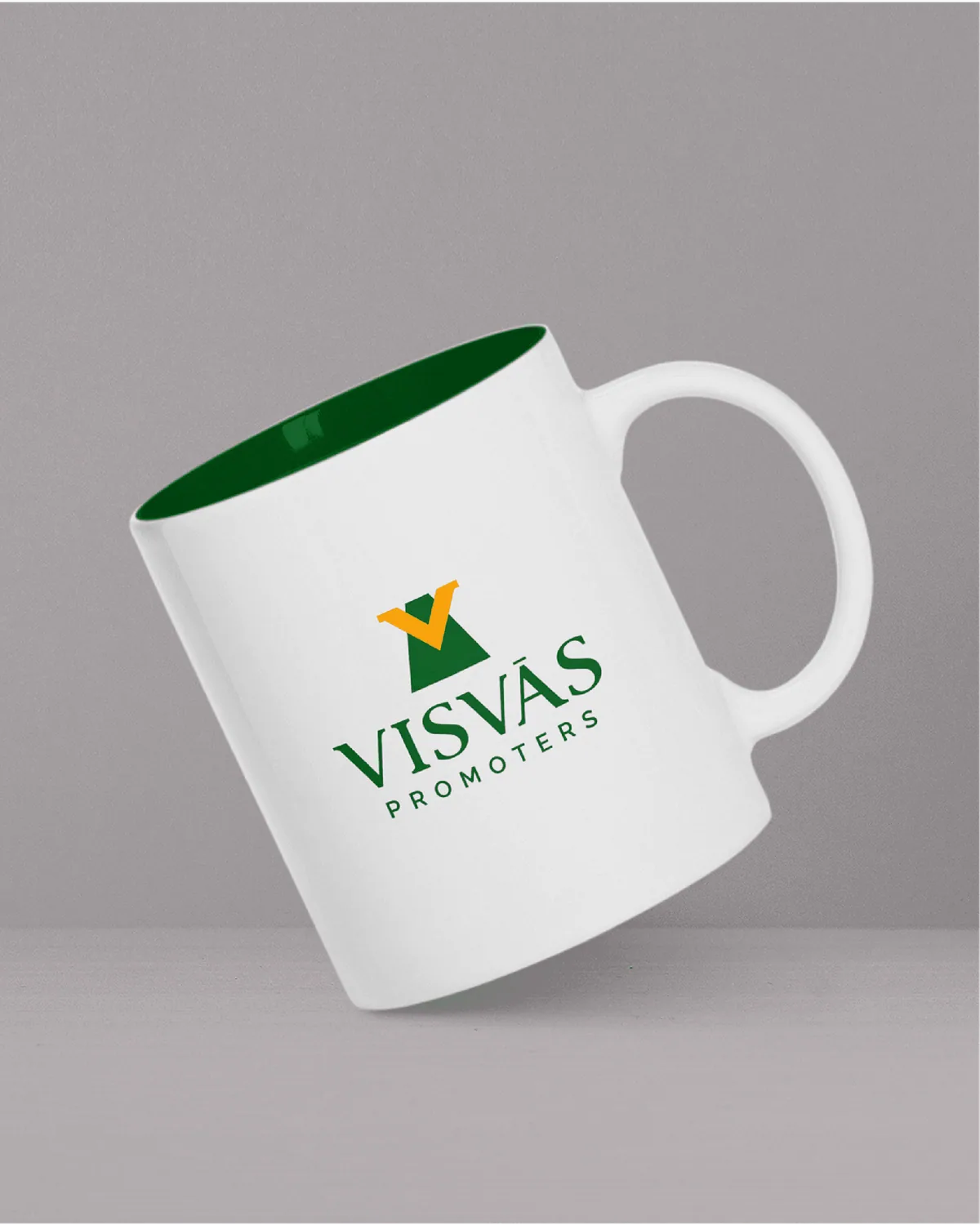 White mug with a green interior and the Visvas Promoters logo