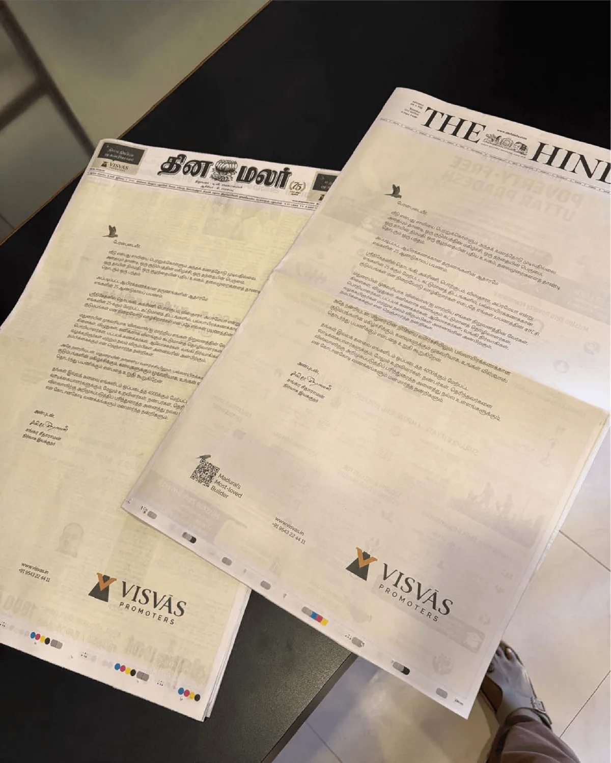 Visvas Promoters letterheads laid over Tamil and English newspapers