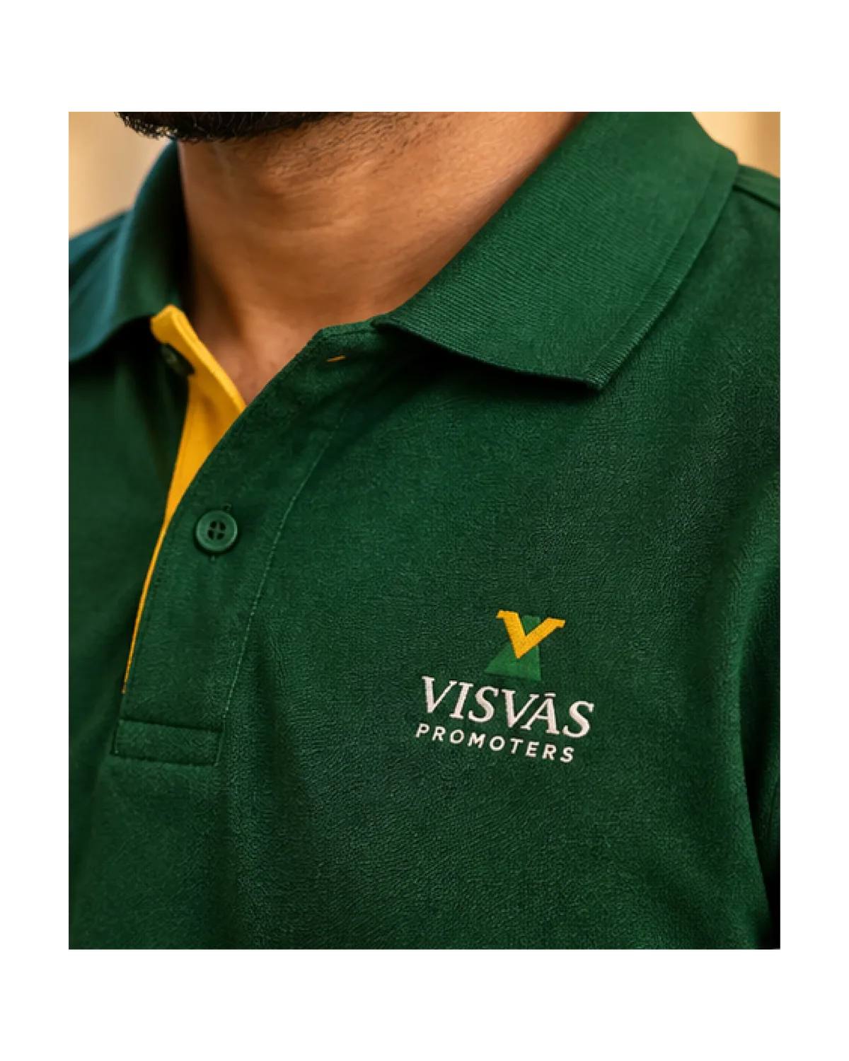 Green polo shirt with the Visvas Promoters logo embroidered on the chest