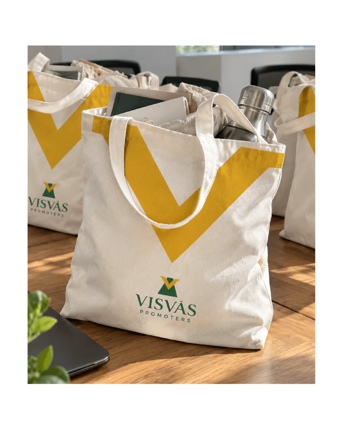 Canvas tote bags printed with the yellow V and the Visvas Promoters logo